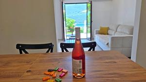 a bottle of wine sitting on top of a wooden table at Villa Sava in Đenovići