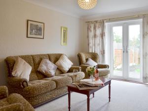 a living room with a couch and a coffee table at The Warren in Seasalter