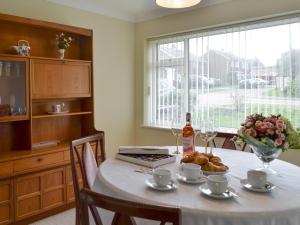 a table with a white table cloth and a bottle of wine at The Warren in Seasalter +6 photos