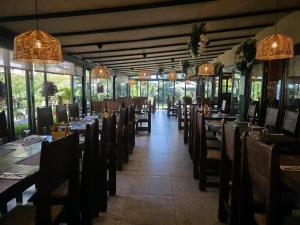 a dining room with tables and chairs and windows at Sobe - Klet Cinkuš in Hrvatski Leskovac