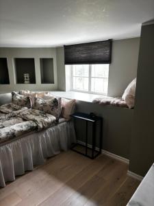 a living room with a couch and a window at Roslags Näsby Täby in Täby