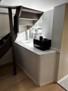 a white room with a table and a black appliance at Roslags Näsby Täby in Täby +14 photos