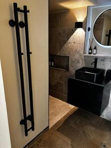 a bathroom with a sink and a mirror at Roslags Näsby Täby in Täby