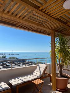 a balcony with a chair and a view of the ocean at Family Hotel Berlin Beach Sveti Vlas in Sveti Vlas
