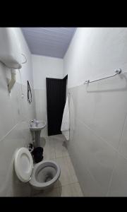 a bathroom with a toilet and a sink at Microcasa 6 in Lajeado