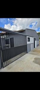 a building with a black and white fence at Microcasa 6 in Lajeado