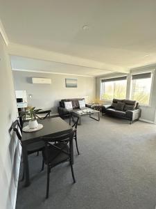 a large living room with couches and tables at Old Pier Apartments in Bridport