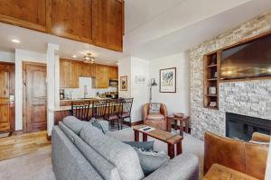a living room with a couch and a fireplace at Lion Square Lodge South 556 in Vail