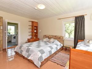 a bedroom with a large bed and a window at Sodyba Po liepom in Krikštonys