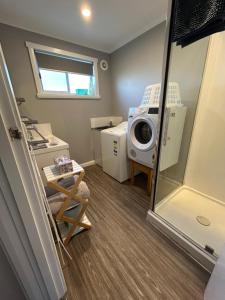 a laundry room with a washing machine and a washing machine at Old Pier Apartments in Bridport