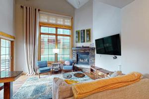 a living room with a couch and a fireplace at Urban Mountain Getaway & Alpenglow Chalet in Steamboat Springs