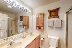 a bathroom with a sink and a toilet and a mirror at Self-Reflection in Pagosa Springs +36 photos