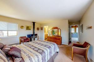 a bedroom with a large bed and two chairs at Self-Reflection in Pagosa Springs
