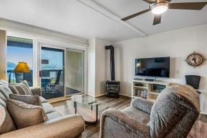 a living room with two couches and a flat screen tv at Lakeside Mountain Retreat in Dillon
