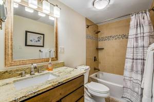 a bathroom with a sink and a tub and a toilet at Lakeside Mountain Retreat in Dillon +27 photos