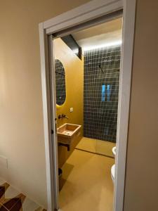 a bathroom with a sink and a toilet and a mirror at Riad Gilda in Torre Canne