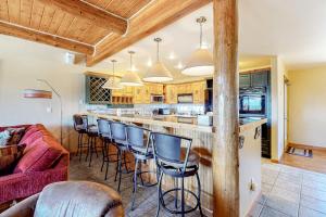a kitchen with a bar with bar stools at Dillon Dreamscape in Dillon