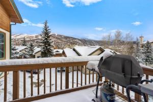 a grill on a balcony with snow on the ground at Evergreens 12 in Steamboat Springs