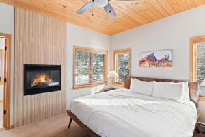 a bedroom with a bed and a fireplace at Evergreens 12 in Steamboat Springs +41 photos