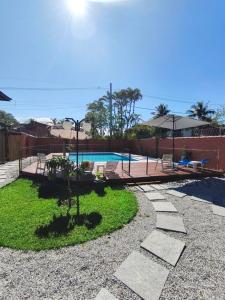 a backyard with a swimming pool and a playground at Quinta do Sahy in São Sebastião