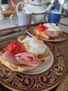two plates of breakfast food on a table at Parciau barn in Clyro
