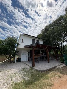a house with a picnic table in front of it at Studio Kolo-M in Blagaj +5 photos