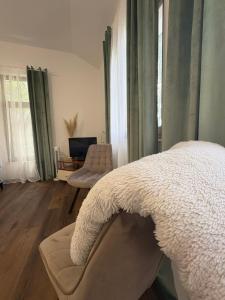 a bedroom with a bed and a living room at Studio Kolo-M in Blagaj