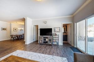 an empty living room with a television and a table at Quail Nest on Quail Drive in Fraser