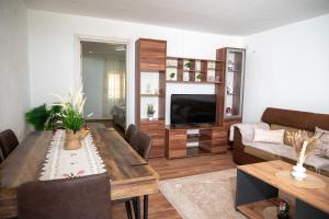a living room with a couch and a table at Endless View House in Gornji Rastiš +18 photos