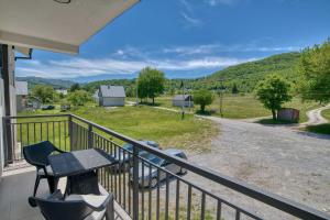 a patio with a table and a grill on a balcony at Milver Apartments Kolasin in Kolašin