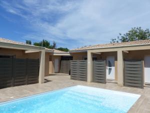 a villa with a swimming pool and a house at Domaine Chante-Cevennes in Frouzet