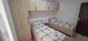 a small room with two beds and cabinets at Pine Apartment 2 plus 1 in Golem