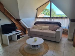 a living room with a couch and a table at Rouvray 21 in Rouvray