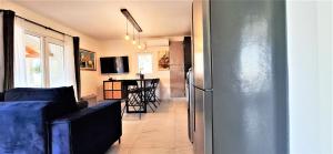 a living room with a refrigerator and a table at Holiday House DA & DO in Pakoštane