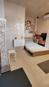 a living room with a bed and a couch at Tiny house 4 metro stops from downtown in San Juan de Aznalfarache