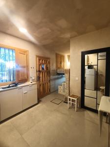 a kitchen with a refrigerator and a counter top at Tiny house 4 metro stops from downtown in San Juan de Aznalfarache