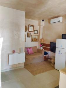 a living room with a couch and a tv at Tiny house 4 metro stops from downtown in San Juan de Aznalfarache