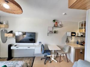 a room with a desk and a tv on a wall at Marina Spatial Condo Unit 16 MountainView Studio in Piapi