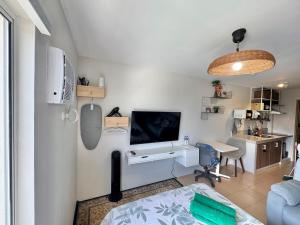 a room with a bed and a desk with a television at Marina Spatial Condo Unit 16 MountainView Studio in Piapi +53 photos