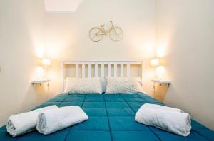 a bedroom with a bed with a bike on the wall at Dogana House in Catania