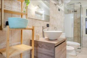 a bathroom with a sink and a toilet at Dogana House in Catania +11 photos