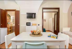 a kitchen with a table with a bowl of fruit on it at Dogana House in Catania