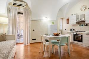 a kitchen and dining room with a table and chairs at Dogana House in Catania