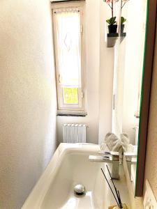 a white bath tub in a bathroom with a window at Il Sogno di Giorgio in Chiavari +40 photos