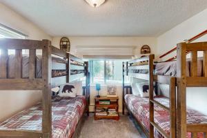 a bedroom with two bunk beds and a window at Hi Country Haus Hideaway in Winter Park