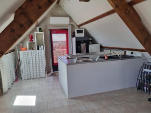 a kitchen with a white island in a attic at Rouvray 21 in Rouvray