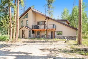 a house with a balcony in the woods at Misty Meadow in Fraser