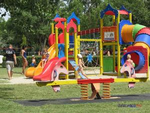 a group of children playing on a playground at Levendula Vendégház in Balatonföldvár