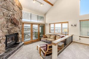 a living room with a large stone fireplace at Railbender 8 in Fraser