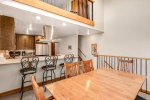 a kitchen and dining room with a wooden table and chairs at Railbender 8 in Fraser